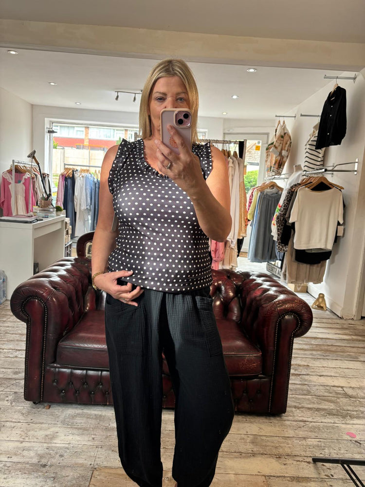 Polka dot ruffle trim vest top in black