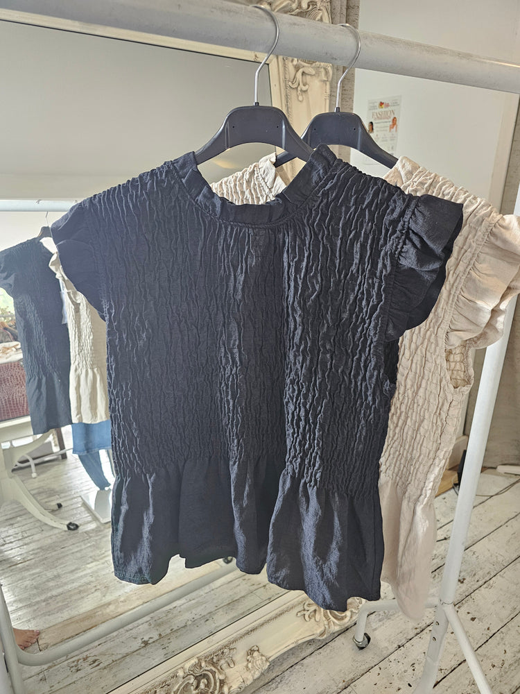 Vivienne smocked peplum top in black