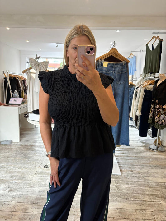 Vivienne smocked peplum top in black