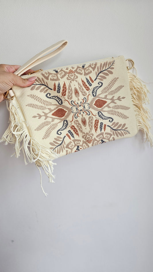 Neutral print clutch with tassels