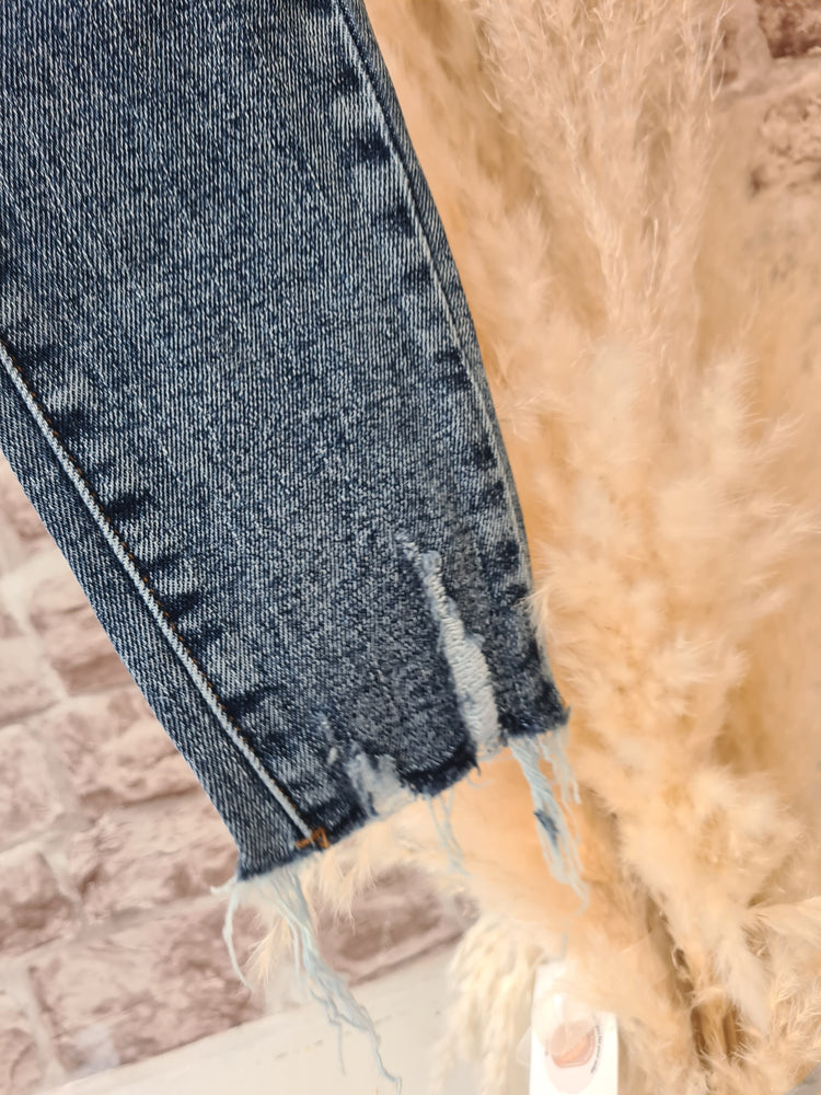 High waisted dark wash frayed bottom jeans